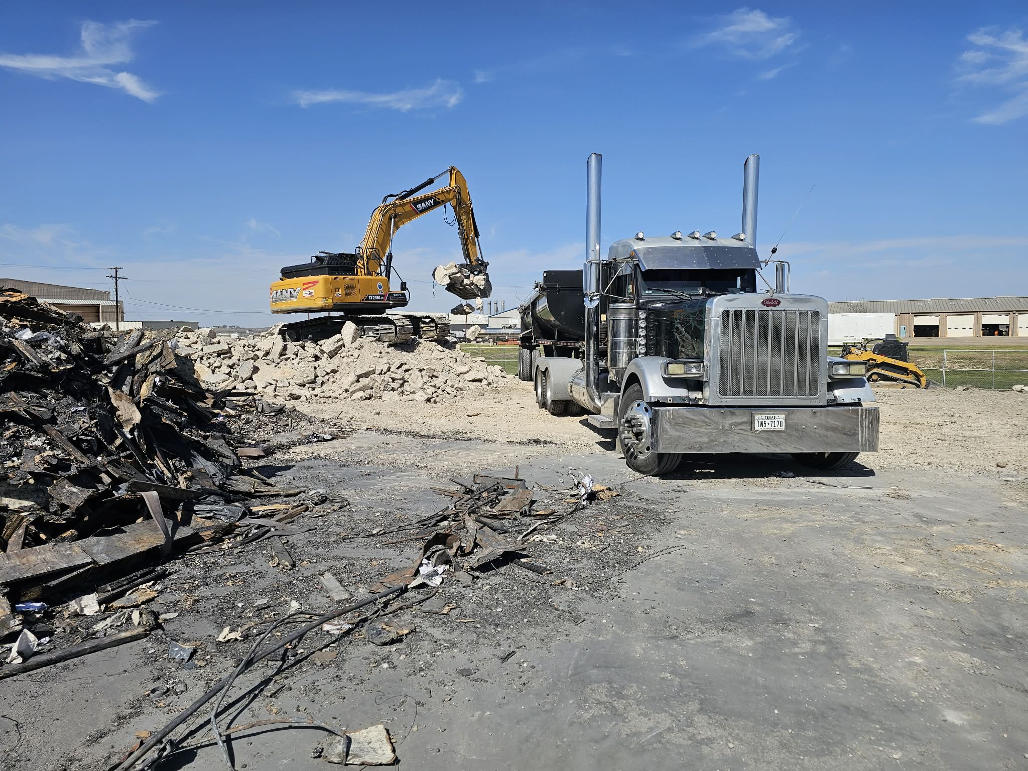 Casias Trucking truck and excavator on a project