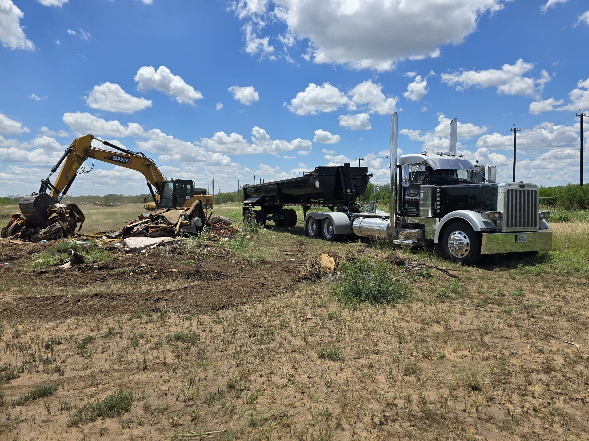 Excavator and dump truck working on site